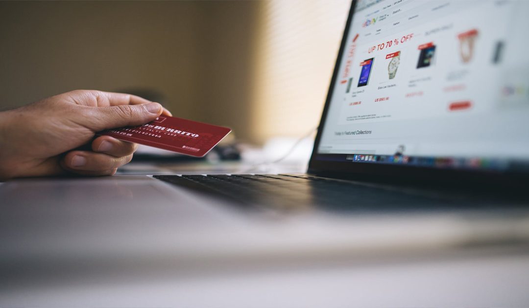 A woman at a computer gets her Experian credit report to prevent identity theft while shopping online.