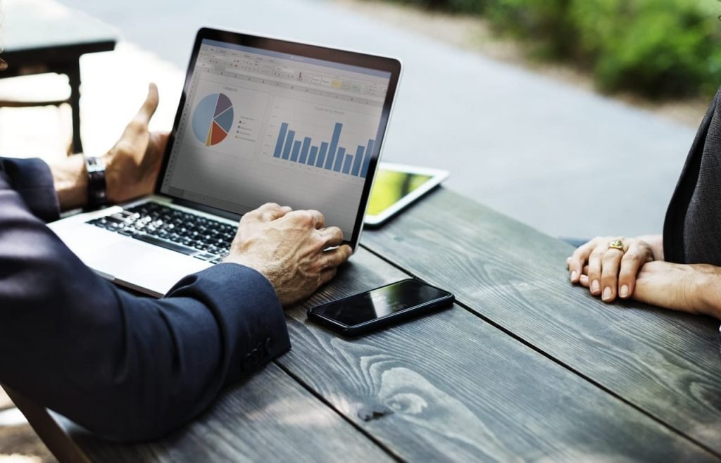 credit counseling featured image Man with laptop discussing financial information with client. Credit counseling can be done face to face, online, or over the phone.