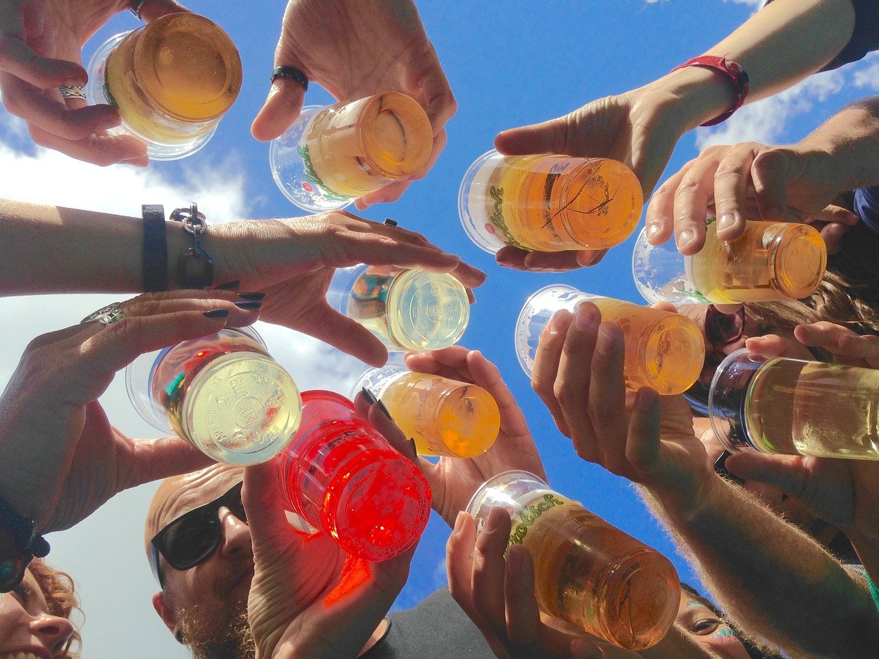 circle of friends drinking different alcoholic drinks