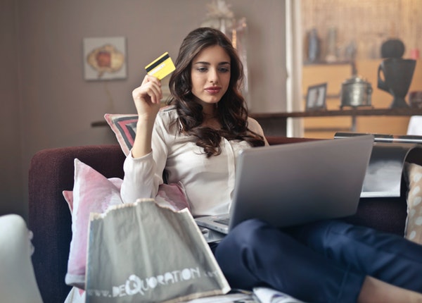 lady shopping online in laptop while holding credit card